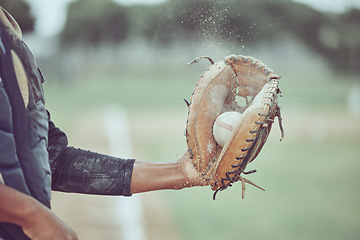 Image showing Baseball, sports and catch with a man athlete catching a ball at a game on a field or grass pitch. Fitness, health and sport with a male baseball player playing a match at a sport venue for exercise