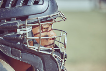 Image showing Baseball, sport and helmet with a sports man on a grass pitch or field during a game for exercise or fitness. Workout, training and competition with a male athlete playing sport at an outdoor event