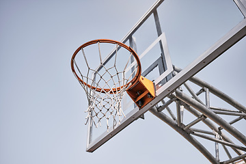 Image showing Basketball court, fabric or goals net for match, competition game or fitness in low angle on blue sky in New York. Basketball hoop, texture or sports exercise for training, wellness or winner workout
