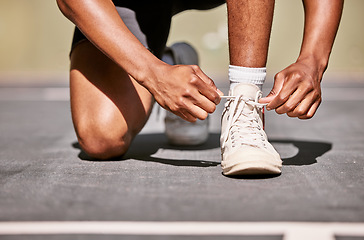 Image showing Man, shoes and laces getting ready for basketball match, game or competition while outdoor in summer. Basketball player, sports and sneakers for running on basketball court before contest in sunshine