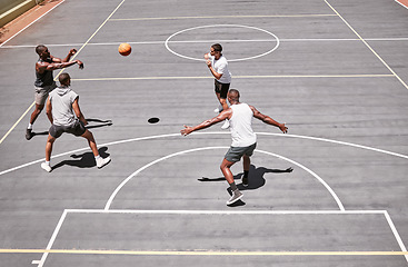 Image showing Fitness, sports and friends training on a basketball court with cardio exercise or workout in summer outdoors in Detroit. Healthy, action and young basketball players playing a game or practice match