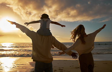 Image showing Family, summer and beach fun of a mother, dad and baby enjoying the ocean at sunset. Mama, father and kid with happiness in nature by the sea water happy about vacation and quality time outdoor