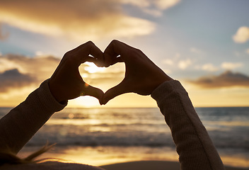 Image showing Beach, love and hands with sunset clouds for peaceful and calm evening horizon view in Mexico. Summer, care and heart hand girl with tranquil ocean sunlight on water and beautiful twilight sky.