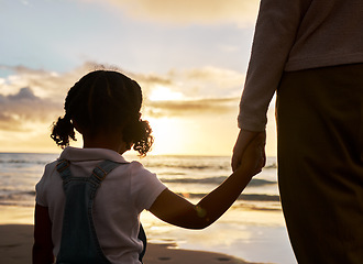 Image showing Hand holding, girl and parent at a sunset, beach waves and ocean with family love and calm mindset. Nature, sea and water view with a child feeling care and relax outdoor with a peaceful experience