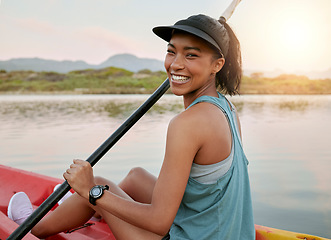 Image showing Relax, smile and kayak with woman on lake for summer, travel and vacation in nature. Adventure, happy and lifestyle with portrait of girl in boat and paddle in water for fitness, holiday and peace