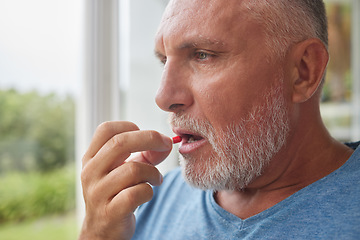 Image showing Retirement man and depression pills in hand for mental health with pensive stare at window. Thinking face of senior male with medicine for self care and wellbeing in Canada nursing home.