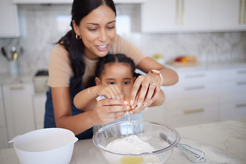 Image showing Egg, baking and family with a mother and girl learning how to bake in the kitchen of their home together. Food, kids and cooking with a woman teaching her daughter how to be a chef or cook in a house