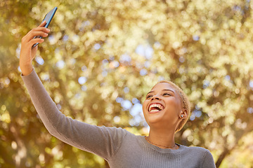 Image showing Selfie, phone and young woman, smile and social media, laugh while outdoor in nature and happy. Gen Z girl from mexico and 5g technology, photo and youth, walking outside in garden or park in autumn