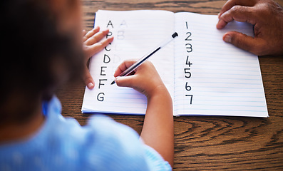 Image showing Teacher, learning and child hands writing in book with tutor for education, alphabet and maths. Knowledge, teaching and student with homework book for studying lesson at desk with top view.