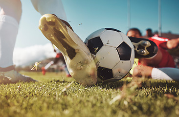 Image showing Soccer, soccer ball and man slide tackle during match, training or competition outdoors. Football, sports and football players on grass field for workout, fitness or exercise game on football pitch.