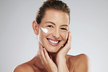 Image showing Cream, face wellness and mature woman with skincare product for health against a grey mockup studio background. Portrait of model with smile and happy about dermatology sunscreen with mock up space