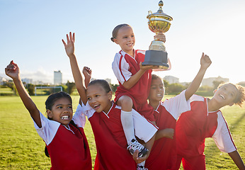 Image showing Trophy, winner and football children with success, winning and excited celebration for sports competition or game on field. Happy soccer girl kids team with motivation, celebrate winning achievement