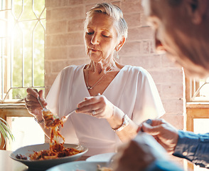 Image showing Old couple eating pasta at restaurant together on a date celebrating anniversary. Food, romantic dinner and senior man and woman enjoying spaghetti in Italian diner for marriage and love celebration