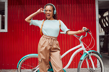 Image showing Girl with bicycle in the city with peace hand sign on red background, listening to music. Summer, young and happy black woman with smile on face, bike and headphones in urban town for songs or radio