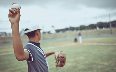 Image showing Baseball, pitcher and athlete throwing a ball on an outdoor field during a game or training. Fitness, sports and softball player practicing his skill at match or exercise on outside pitch or stadium.