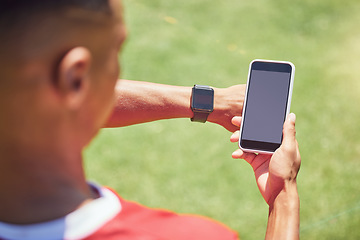 Image showing Green screen, soccer player and phone on field with smartwatch, tech or mockup on mobile digital app. Man, football player or smartphone on social media, web or 5g network at training, game or match