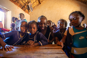 Image showing Happy Malagasy school children students in classroom. School attendance is compulsory, but many children do not go to school.