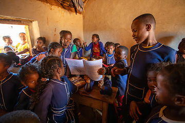 Image showing Happy Malagasy school children students in classroom. School attendance is compulsory, but many children do not go to school.