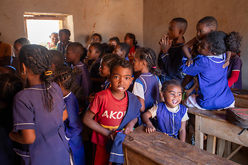 Image showing Happy Malagasy school children students in classroom. School attendance is compulsory, but many children do not go to school.