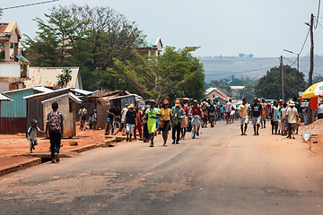 Image showing Candid street photography of local residents walking and going about their daily lives on Mandoto street in Madagascar.