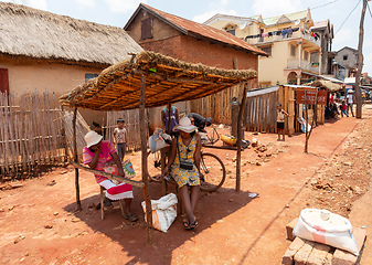 Image showing Street market in Mandoto city, with vendors and ordinary people shopping and socializing. This image portrays the local lifestyle and economy of Madagascar.