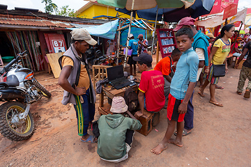 Image showing Malagasy man repairs phones on the street. Miandrivazo, Madagascar