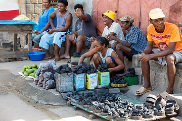 Image showing Street market in Miandrivazo, woman selling charcoal. Madagascar