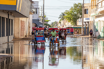 Image showing Traditional rickshaw bicycle with Malagasy people on the street of Toliara, one of the ways to earn money. Everyday life on the street of Madagascar.