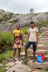 Image showing Young man and woman standing on a rocky trail in a mountainous area