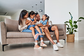 Image showing Mother, father and children laughing on sofa together, having fun and bond on weekend. Love, affection and multicultural family on couch in living room. Happy parents playing with kids in family home