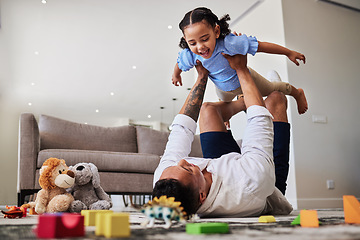 Image showing Dad, lying and lifting with child, airplane or playing in living room for care, bonding and happy. Father, girl and floor with toys, game or plane with legs in house, lounge or apartment with love