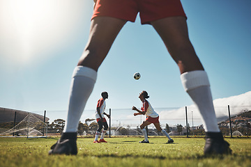 Image showing Sports, summer and soccer ball on head, young men on field during training exercise. Health, fitness and ball header at football game, players on grass together for practice workout or competition.