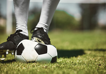 Image showing Soccer player feet, deflated soccer ball and sports, competition game and training on grass field, pitch and lawn. Closeup footballer boots puncture, broken and decrease air problem of flat equipment