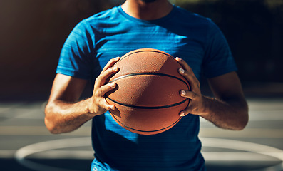 Image showing Basketball player, man hands and ball in basketball court, outdoor training or sports goals competition game, champion workout and fitness. Closeup basket ball athlete coach in community playground