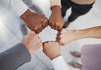 Image showing Diversity, hands and team fist above in support, trust and unity for collaboration, agreement or meeting at the office. Group hand of diverse people in teamwork, cooperation and solidarity for fight