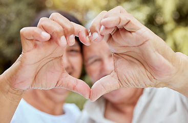 Image showing Heart hands, love and senior couple, happiness and kindness, trust and support in garden park. Closeup marriage, finger shape and celebrate care relationship, anniversary date and relax retirement