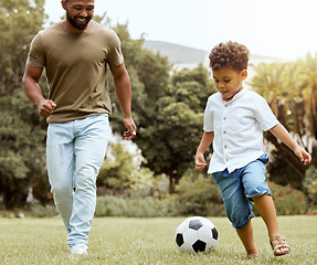 Image showing Man, boy and bonding with soccer ball in garden, house backyard or nature grass park for fun game, match and competition. Smile, happy and football for father and kid in fitness, exercise and workout