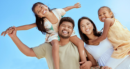 Image showing Happy family, couple with girl children and blue sky on outdoor summer vacation in Asia. Happy Asian mother, father and kids with piggy back fun playing in the sun and spending quality time together.