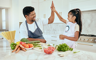 Image showing Food, family and high five with girl and father in a kitchen preparing a meal, bonding and having fun in their home. Love, kids and parent help, trust and support while cooking a balanced dinner