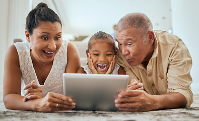 Image showing Relax, digital tablet and family on floor in living room, wow and happy with online cartoon or animation in Mexico. Happy family, grandparents and girl bond, watch and enjoy internet fun together