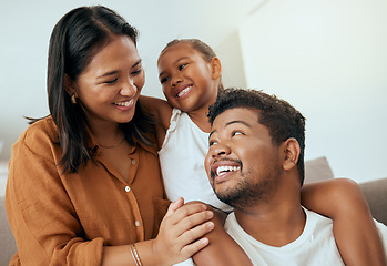 Image showing Love, family and relax on a sofa bonding, smile and embracing in a living room with happy, cheerful people. Happy family, quality time and child with parents having fun and enjoying cosy conversation