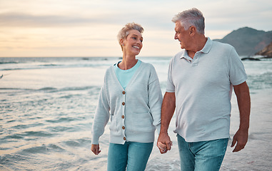 Image showing Beach, holding hands and senior couple with sunset for outdoor wellness, retirement holiday and outdoor date mock up sky. Happy elderly people, or old man and old woman walking by sea or ocean water