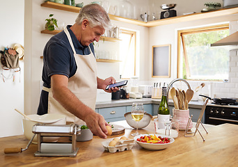 Image showing Senior man, cooking and phone for recipes, research or ingredients for the perfect meal in the kitchen at home. Elderly male cook or baker with food browsing online recipe or streaming on smartphone
