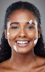 Image showing Black woman, beauty and facial skincare moisturizer, cream or lotion with smile for cosmetics against grey studio background. Portrait of happy African American female face smiling for skin treatment