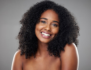 Image showing Happy, smile and portrait of a young woman with clean, beautiful and natural hair in a studio. Happiness, beauty and face of girl model with afro from Brazil smiling while isolated by gray background