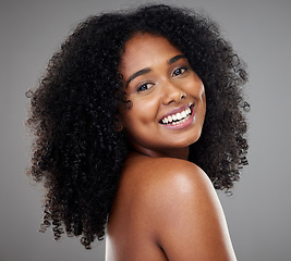 Image showing Black woman afro, beauty and smile for skincare, cosmetics or treatment against grey studio background. Portrait of happy isolated African American female smiling with teeth in care for perfect skin