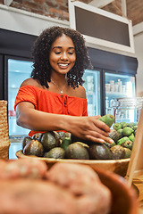 Image showing Black woman at supermarket, grocery shopping and avocado, customer and retail, vegetable fresh product and buying food at store. Young, African American and smile, sale and discount on groceries.