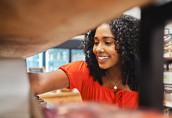 Image showing Shelf, store and shopping black woman in grocery shop, choice or select food products. Retail, supermarket and female customer from Nigeria choosing goods in small business, market or grocery store.