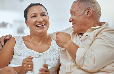 Image showing Relax, elderly couple and coffee in a living room with happy, smile and peaceful seniors embracing in their home. Retirement, tea and break with mature man and woman enjoying cozy conversation