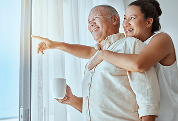 Image showing Mature couple, hug or pointing out window in house, home or retirement holiday hotel with morning coffee. Smile, happy or elderly man and love woman in show hand gesture at bonding travel hospitality